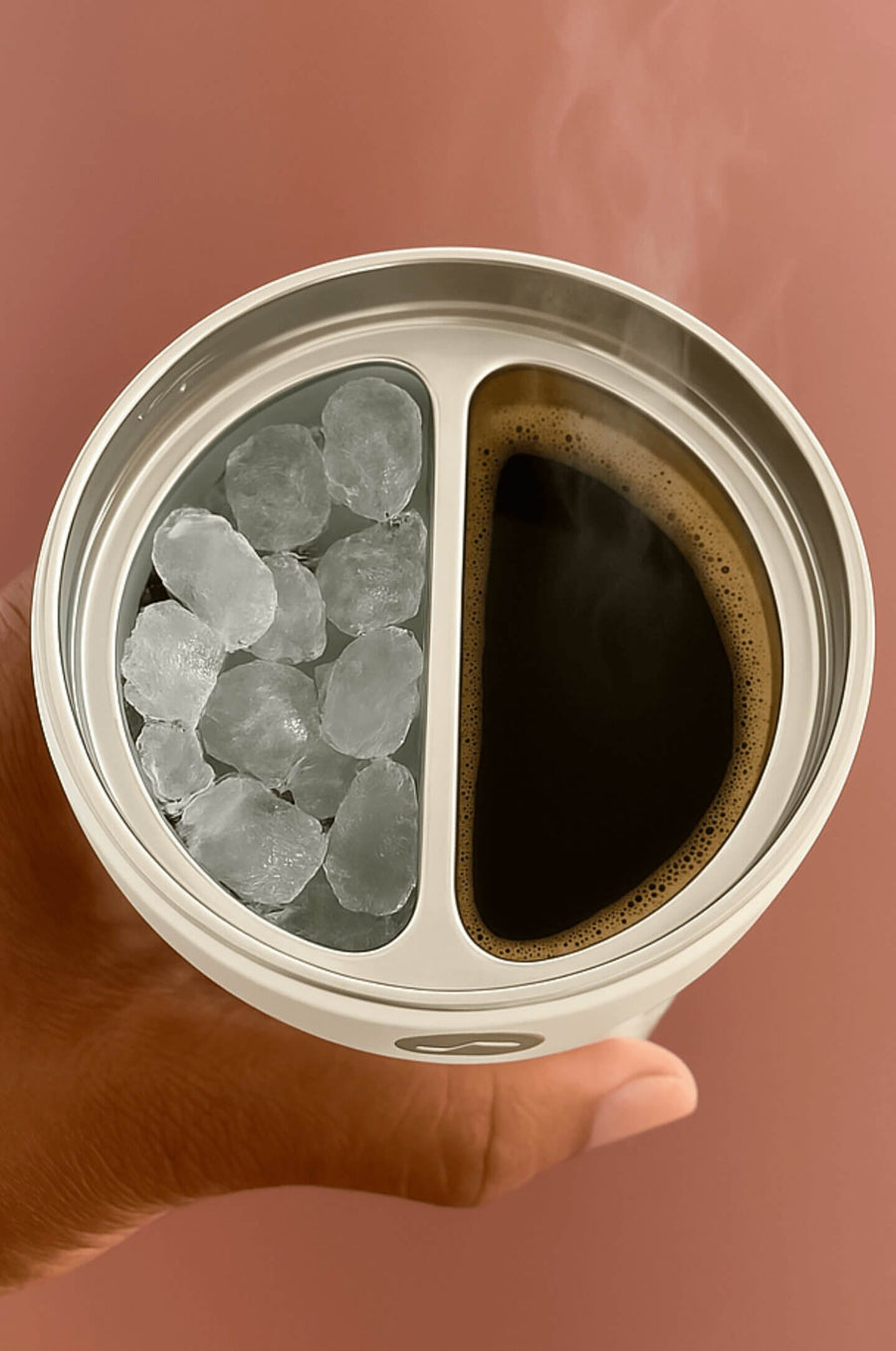 Hand holding a two-part container with ice on one side and coffee on the other against a brown background