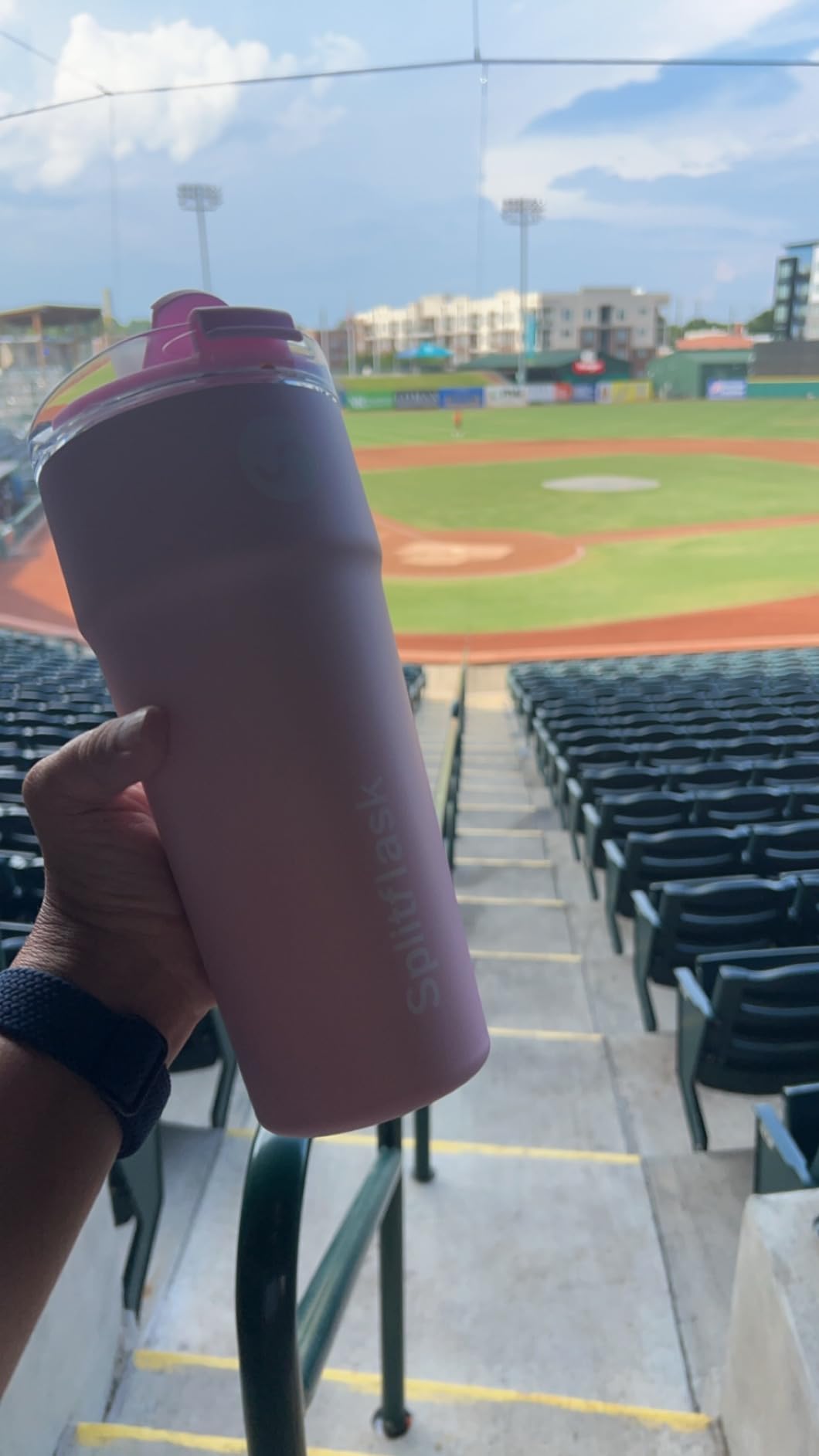 Customer holding a mauve Splitflask at a baseball stadium